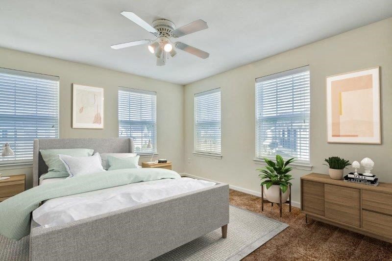 a bedroom with a bed and a ceiling fan