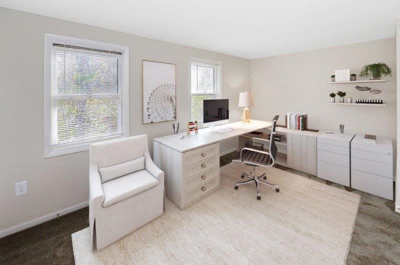 a white office with a desk and a chair