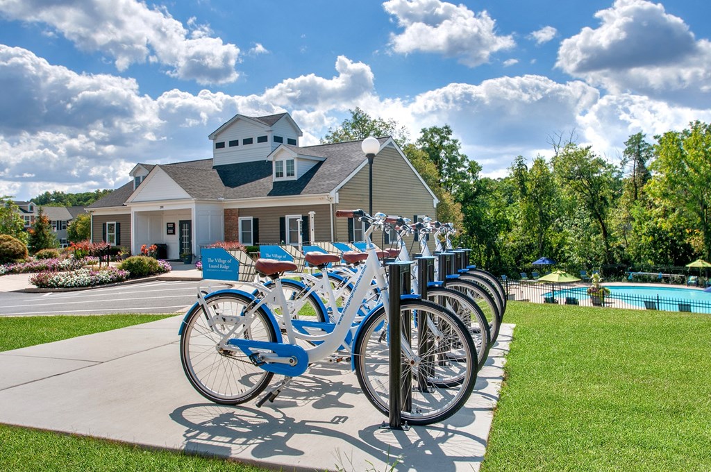 a row of rental bikes parked in front of a house