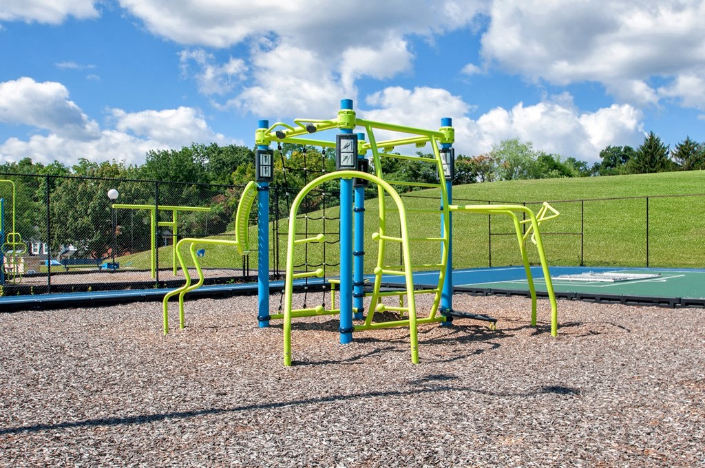a blue and yellow swing set on a playground