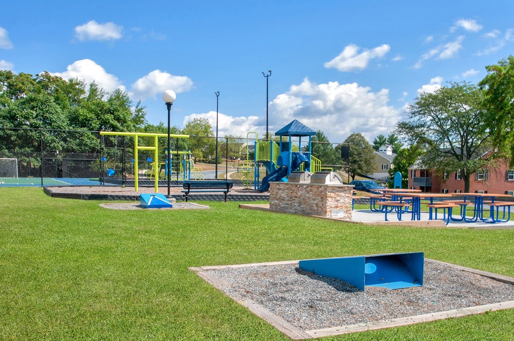 a playground with a picnic table and other playground equipment