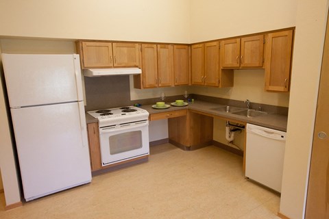 a kitchen with a stove refrigerator and sink
