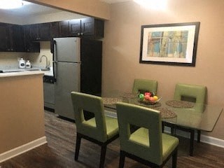 A kitchen with a table and chairs.
