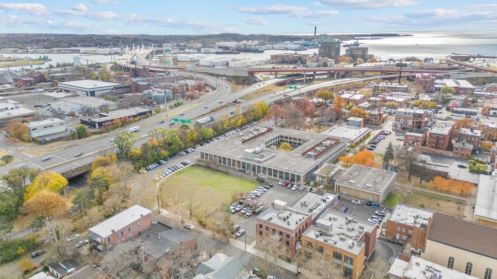 an aerial view of a city with a river in the background