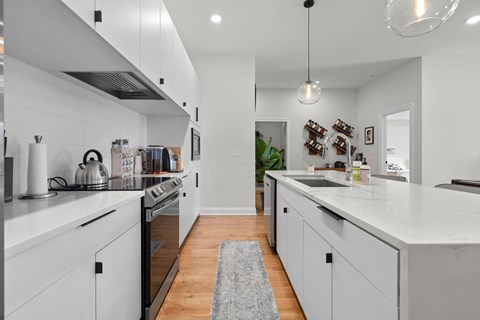 a kitchen with white cabinets and a white counter top