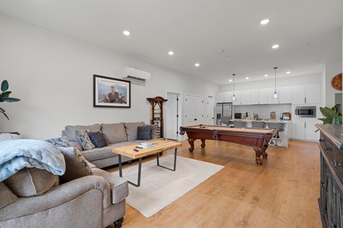 a living room with a pool table and a couch
