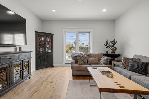 the living room has a fireplace and a couch and a coffee table