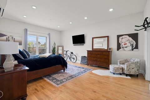 a bedroom with a bed and a tv