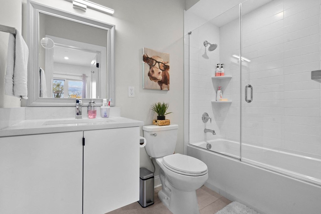 a white bathroom with a shower and a toilet