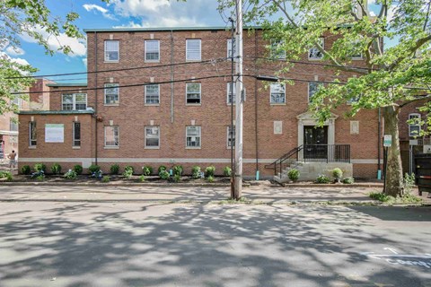a large brick building with a street in front of it