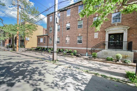 a brick apartment building with a street in front of it