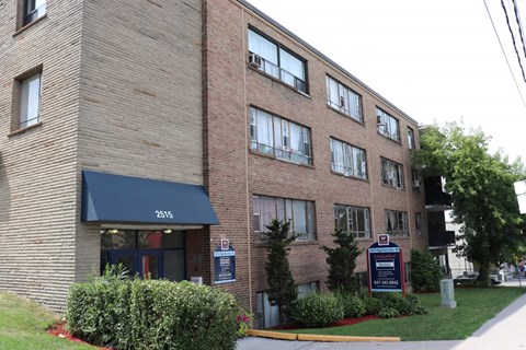 a brick building with a sign in front of it
