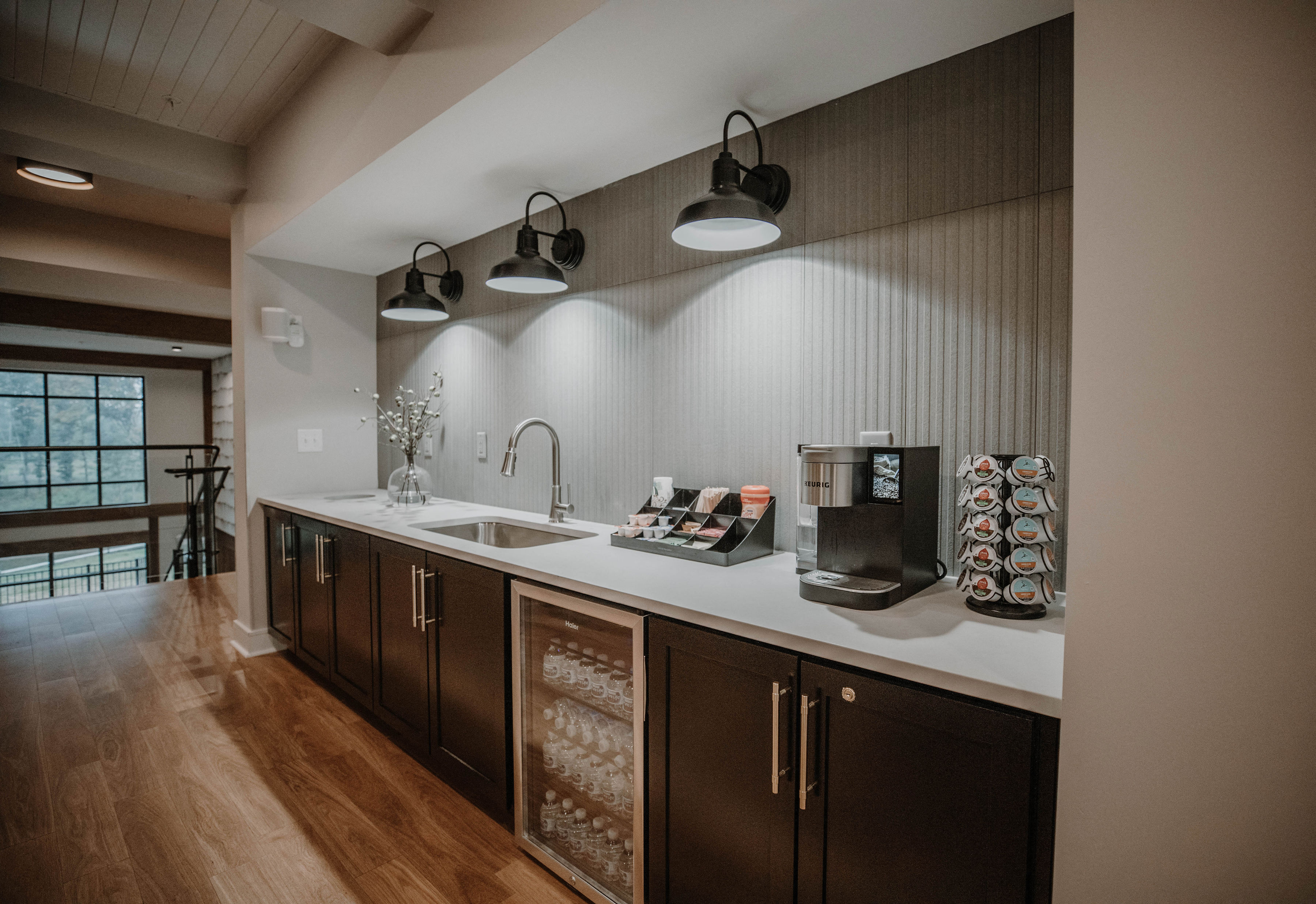 a kitchen with a sink and a coffee maker on the counter