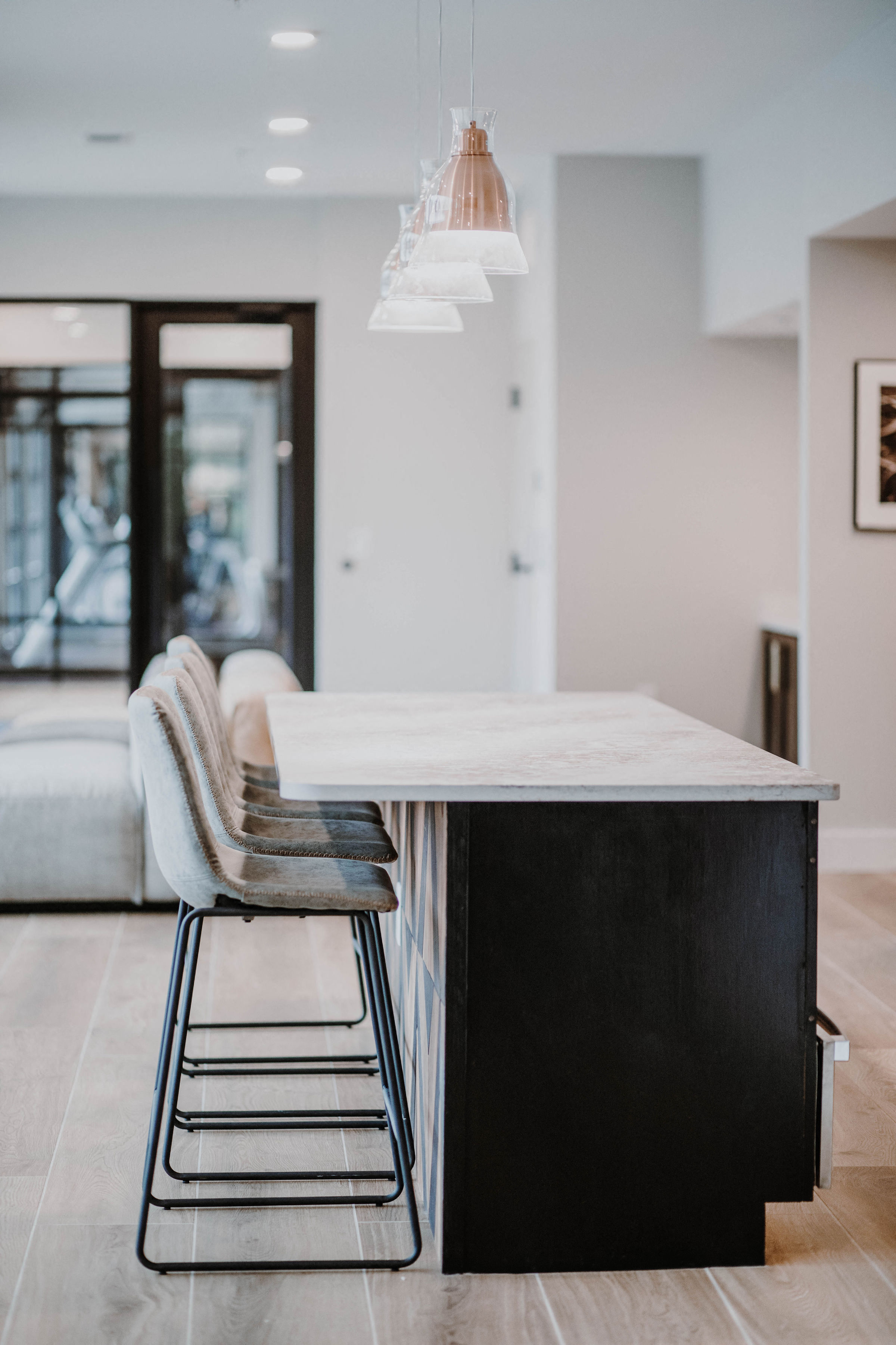 a kitchen with a marble counter top and two chairs