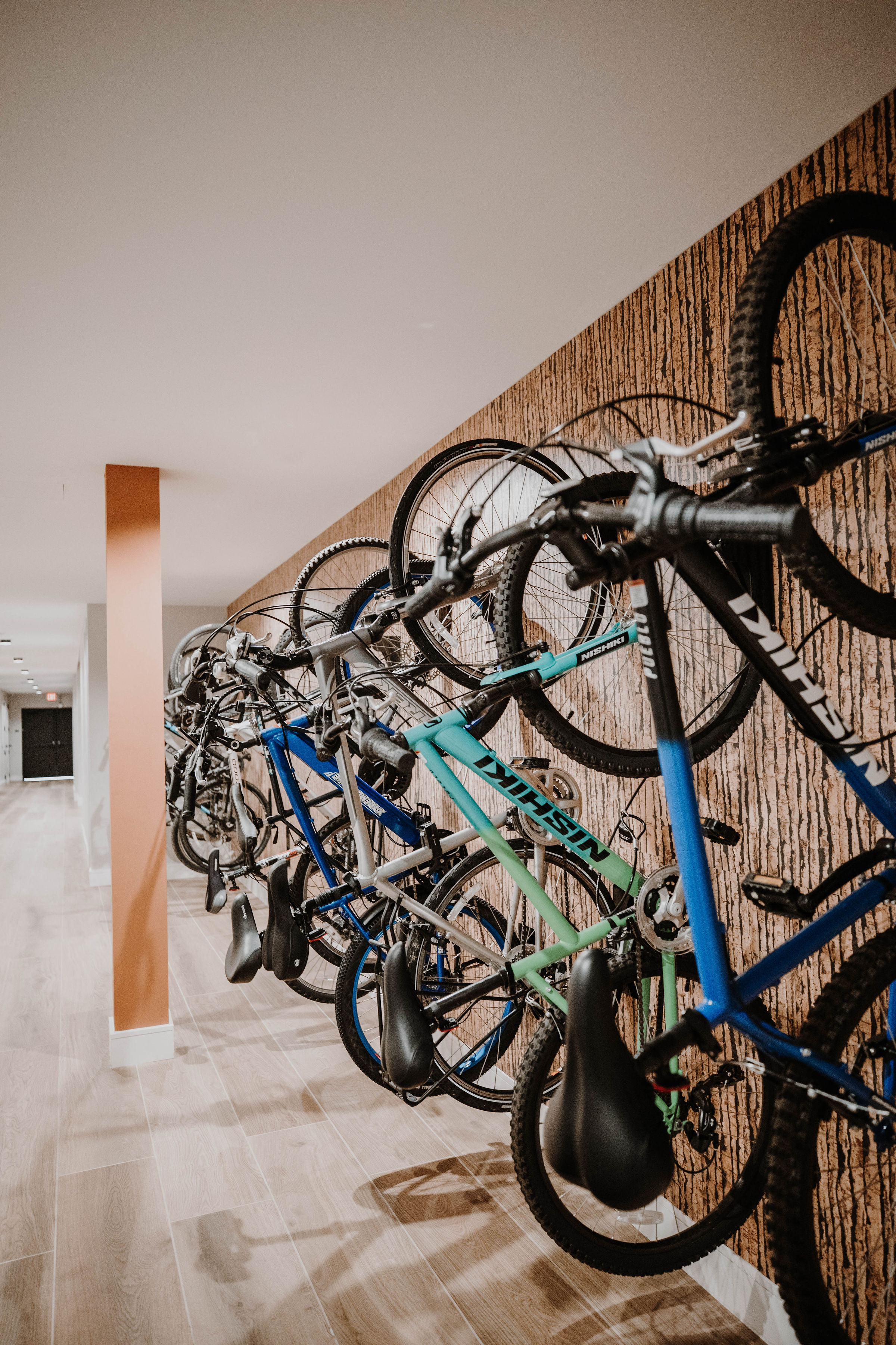 a row of bikes on a wall in a hotel room