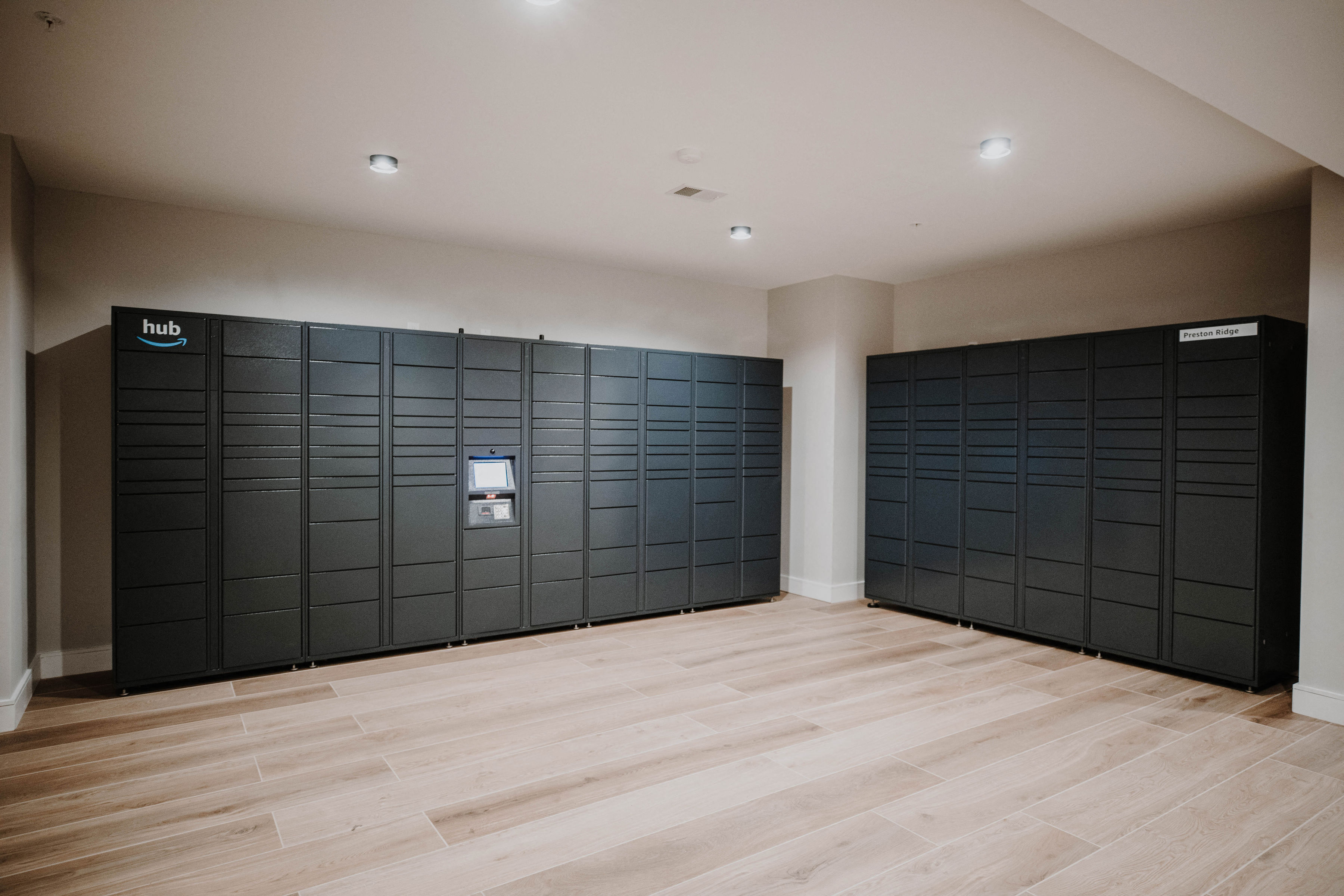 a row of black lockers in a room with wooden floors