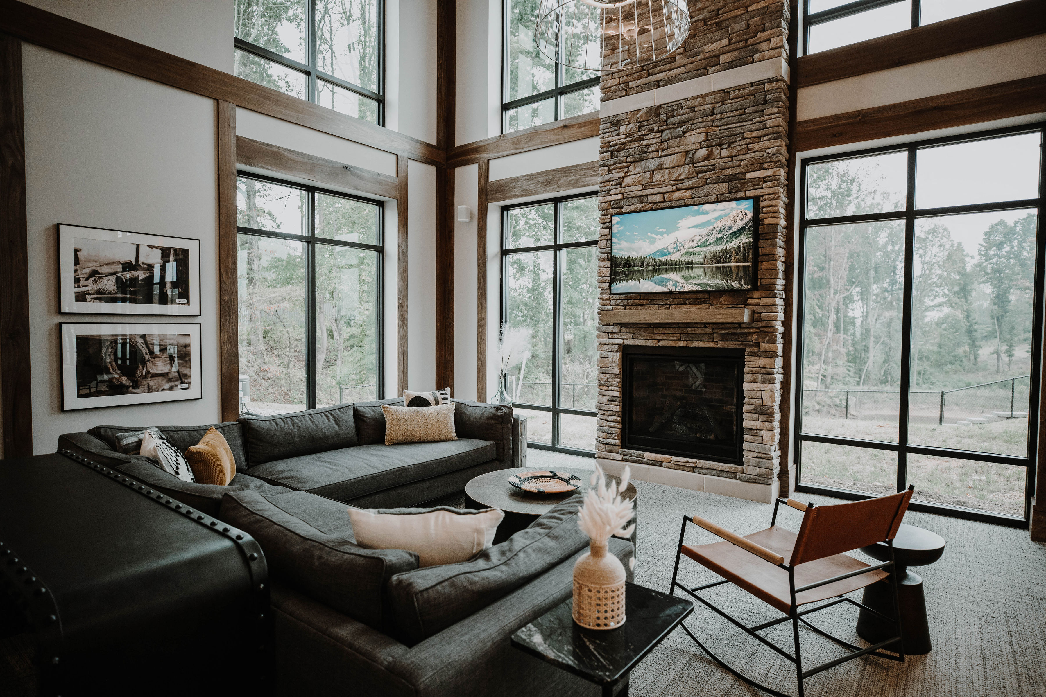 a living room with a leather couch and a fireplace