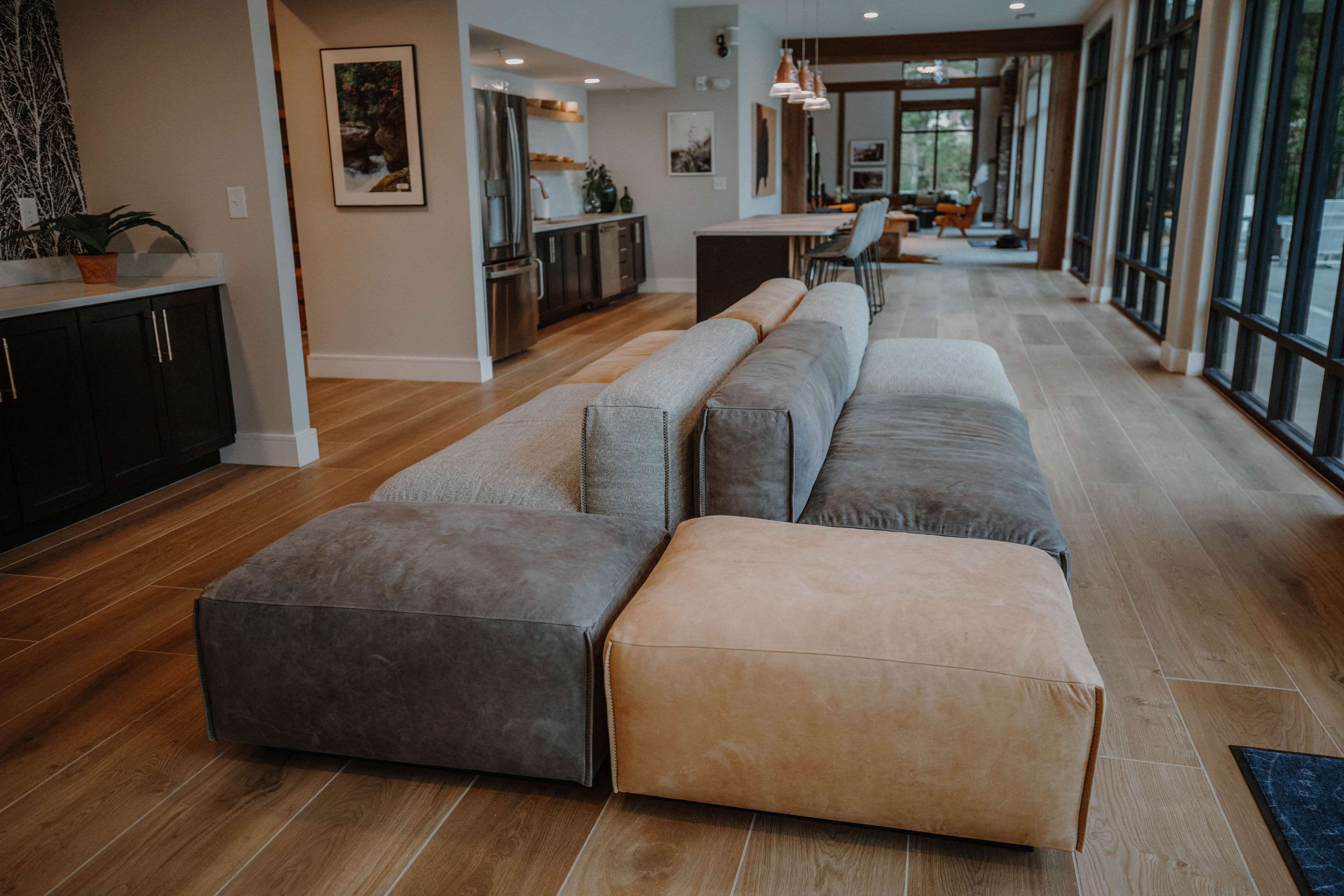 a long living room with a couch and a dining room
