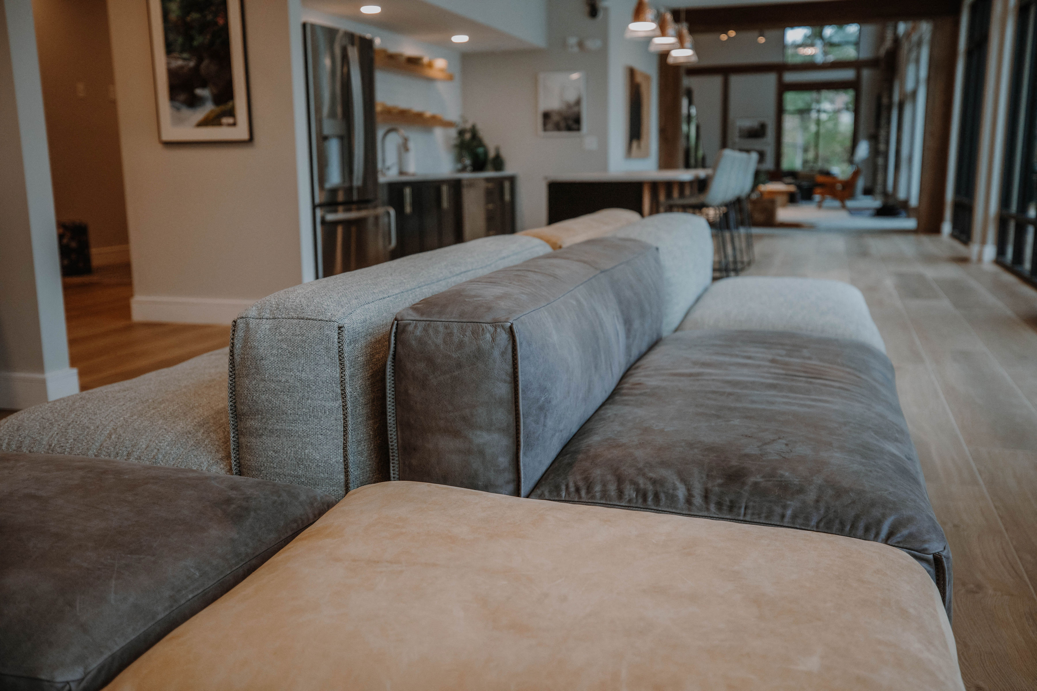 the living room has a long couch with pillows