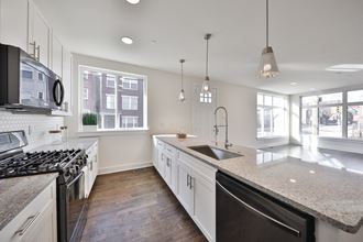 a large kitchen with granite counter tops and stainless steel appliances