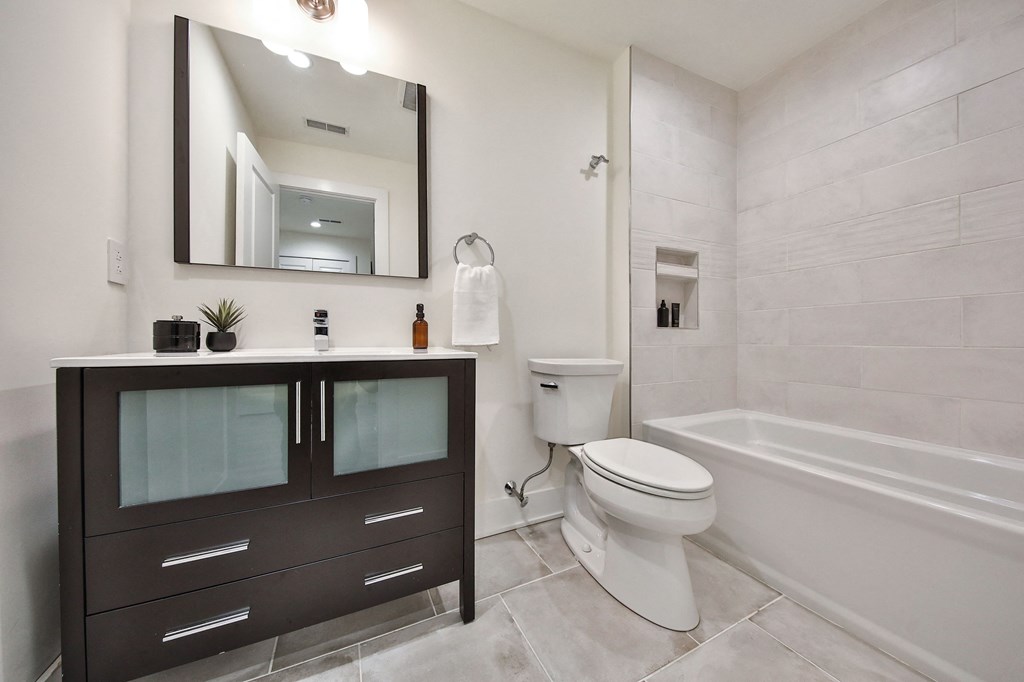 a bathroom with a sink and a toilet and a bath tub