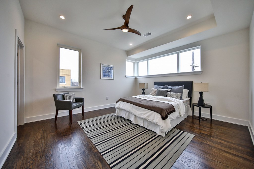 a bedroom with a bed and a ceiling fan