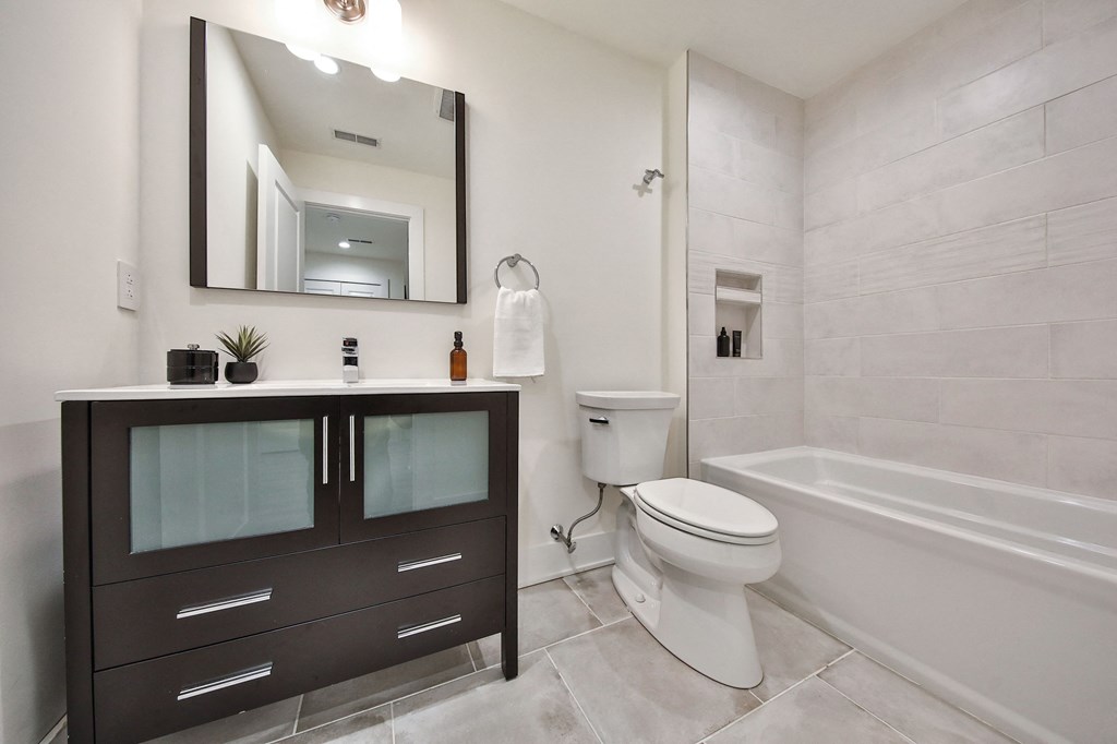 a bathroom with a toilet and a sink and a bath tub