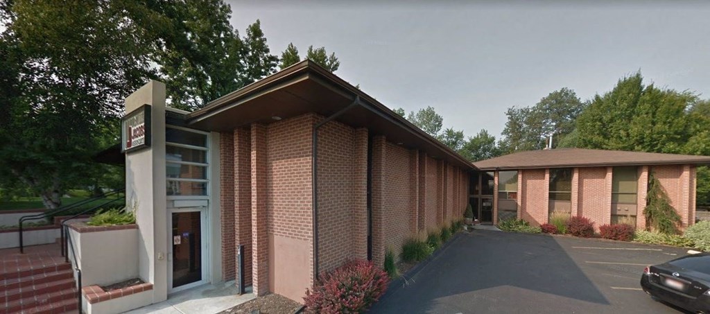 a brick building with a car parked in front of it