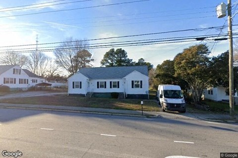 a van parked in front of a white house