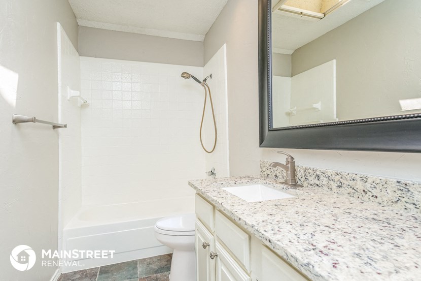 a bathroom with a sink and a toilet and a shower