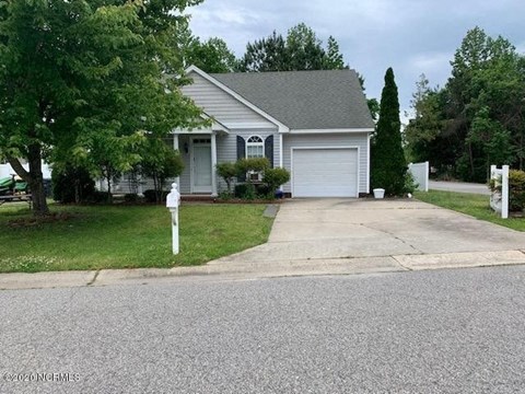 a house with a driveway and a parking meter