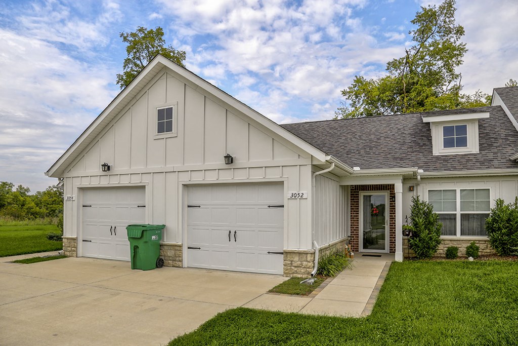 a white house with a garage and a driveway