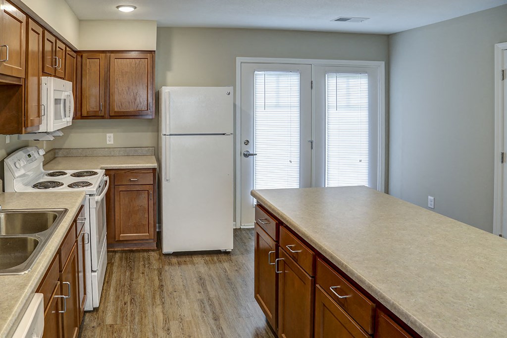 a kitchen with wooden cabinets and a white refrigerator