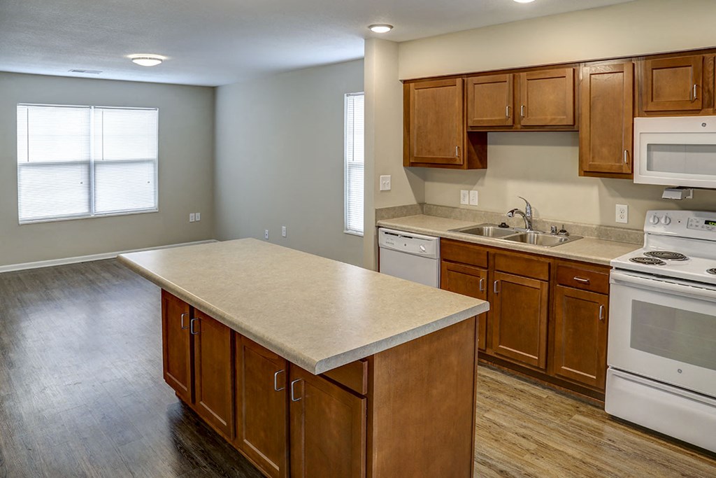 an empty kitchen with wooden cabinets and a counter top