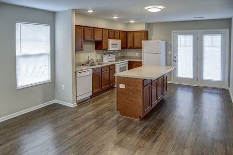 a kitchen with wooden floors and a white refrigerator