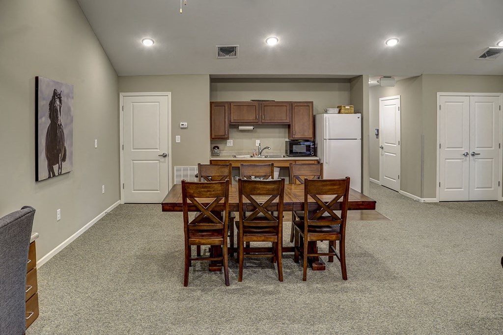 a kitchen and dining room with a table and chairs