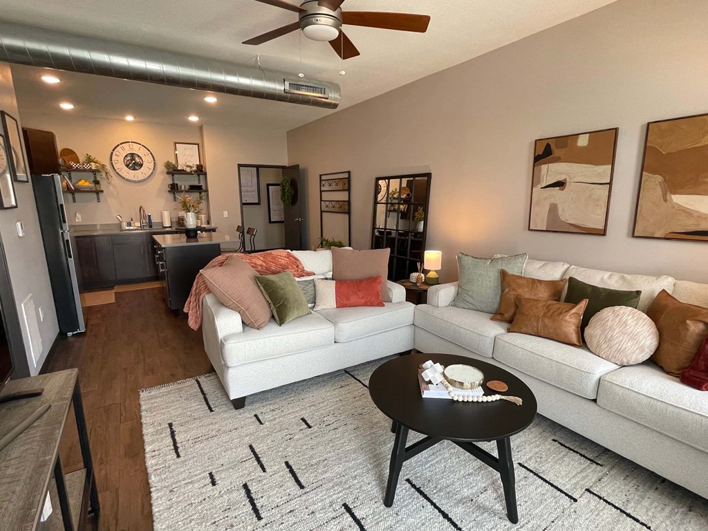 A living room with a white couch and a coffee table.
