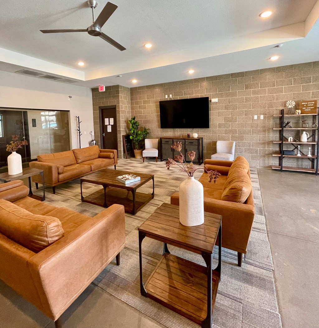 A living room with brown leather couches and a wooden coffee table.