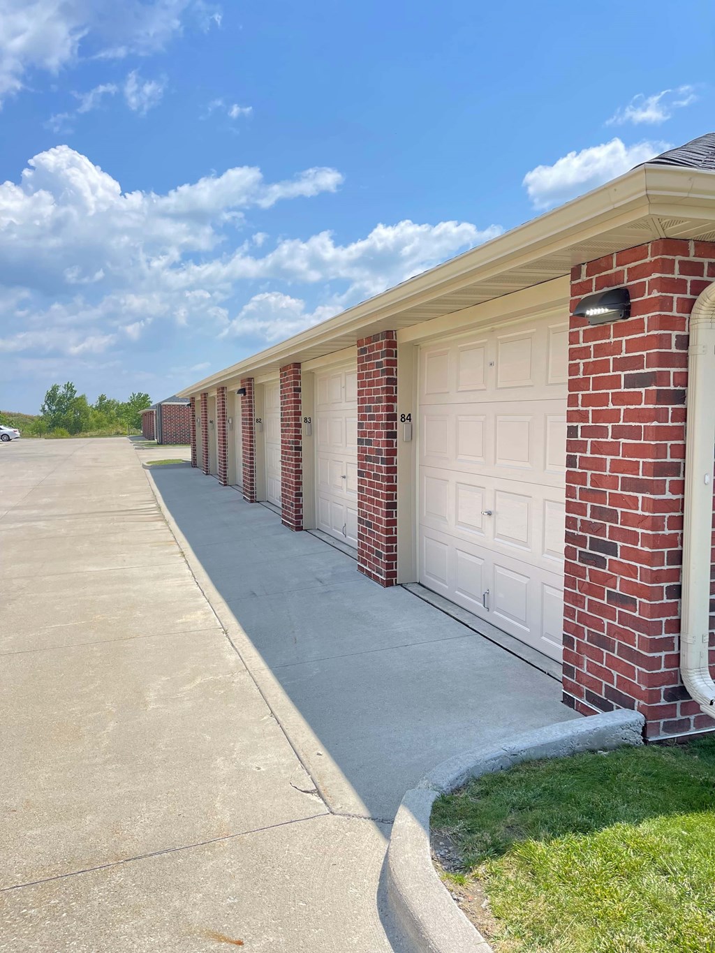 A row of garages with the number 64 on the first one.