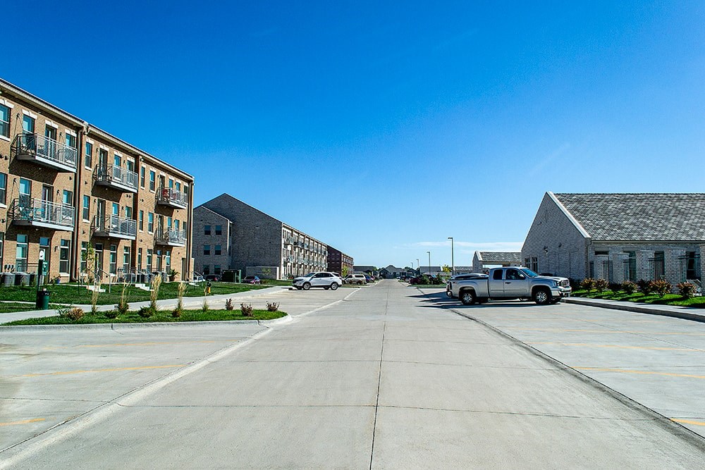 A street with cars and buildings on both sides.