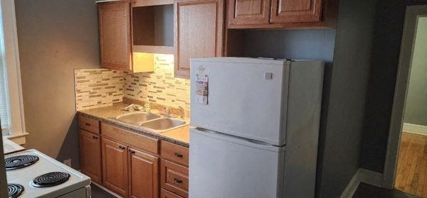 a kitchen with a refrigerator and a sink