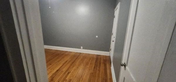 a room with a wooden floor and a white door