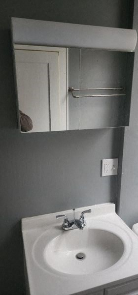 a bathroom with a white sink and a mirror