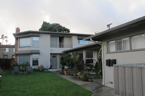 the exterior of a house with a yard and a patio