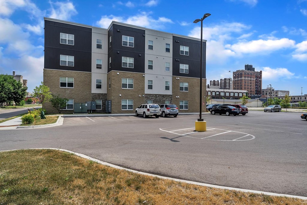 an empty parking lot in front of an apartment building