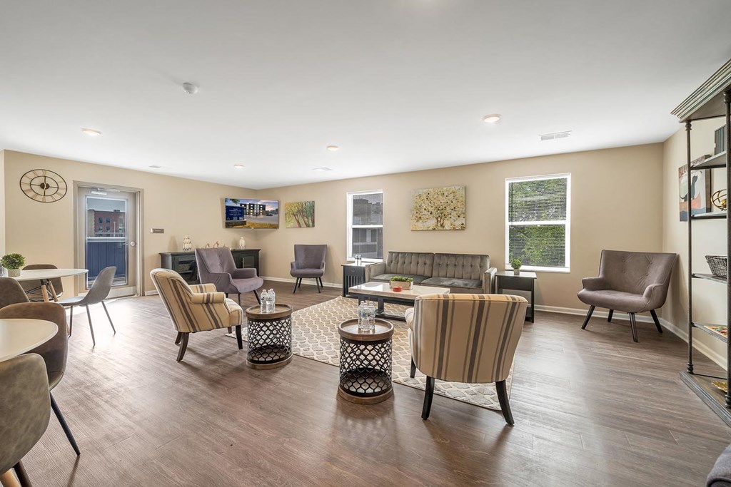 a living room with a couch and chairs and a table