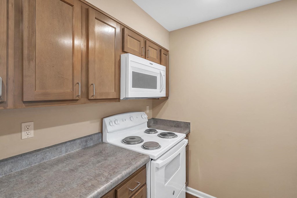 a kitchen with a stove microwave and cabinets
