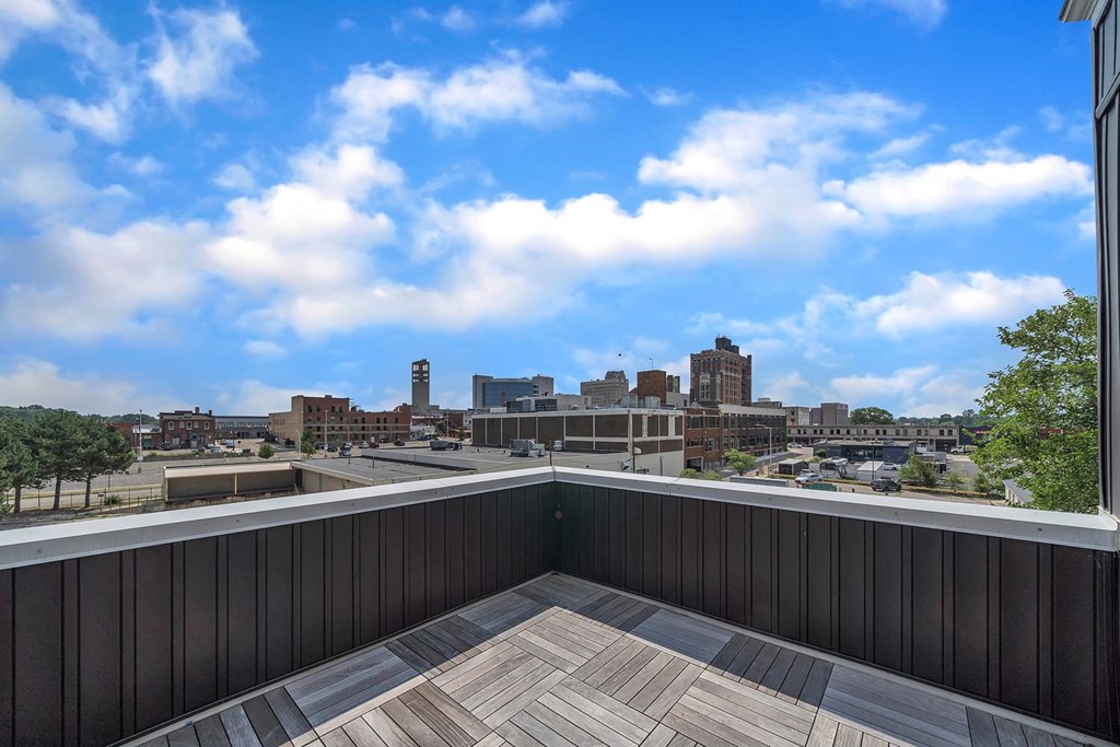 the view of the city from the rooftop deck of a building