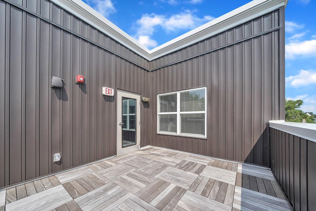 the front of a building with a patio and a door