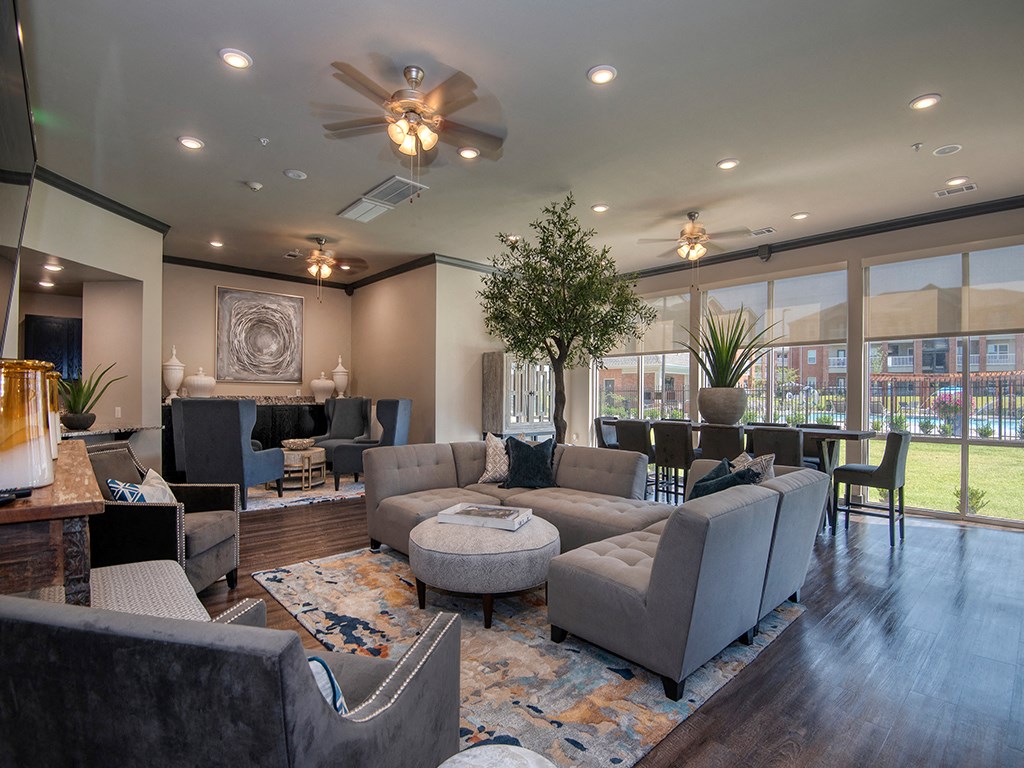 a large living room with couches and chairs and a table